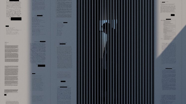 black and white text with sections blacked out, displayed on a pale gray wall outdoors