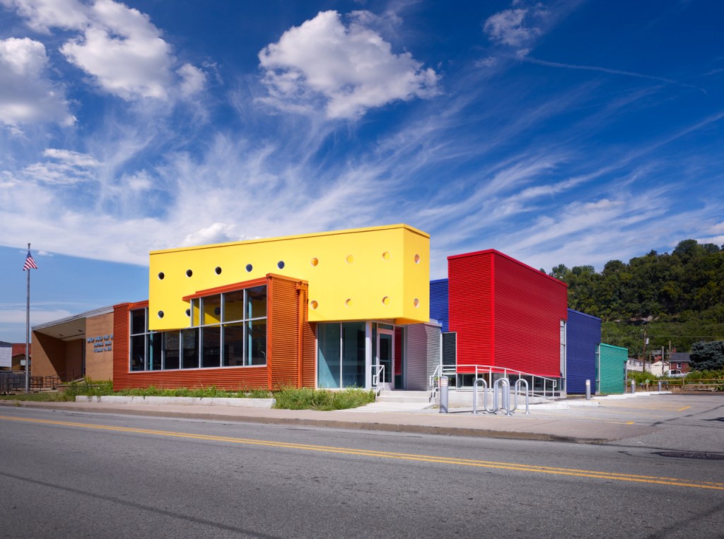 a building made up of rectangular prisms, where the individual prisms seem to collide and slice to each other - the building uses bright primary colors