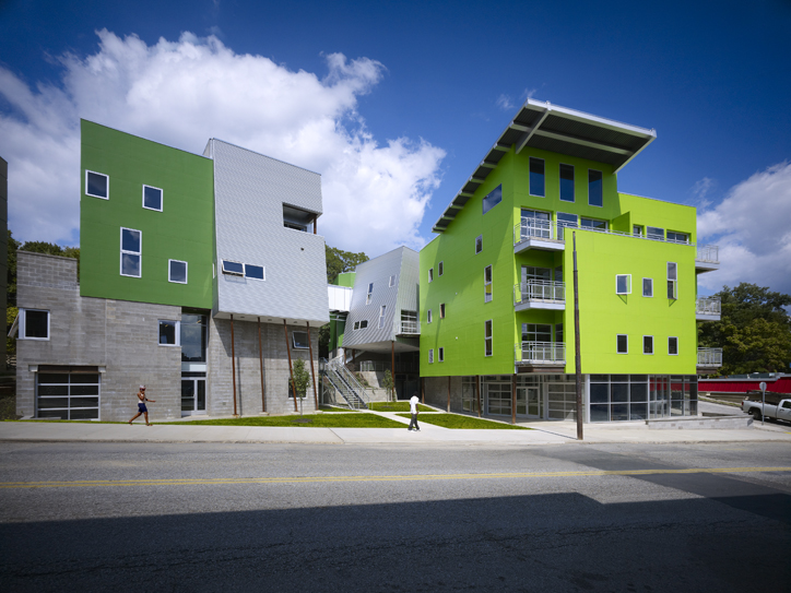 lime green and gray buildings - the exterior of some sides of the building are slanted, and the windows seem almost randomized